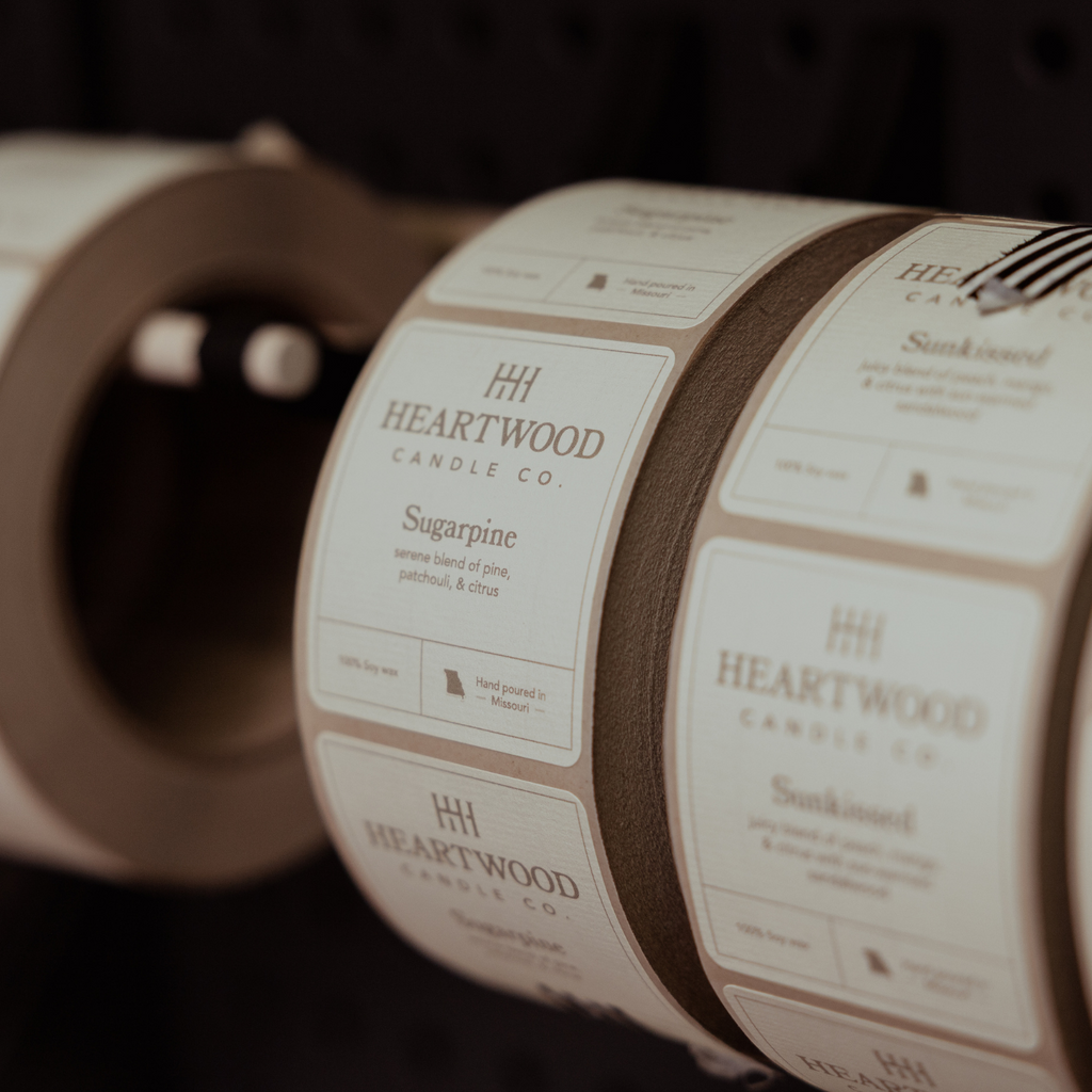 Fall soy candles being labeled by hand in Missouri