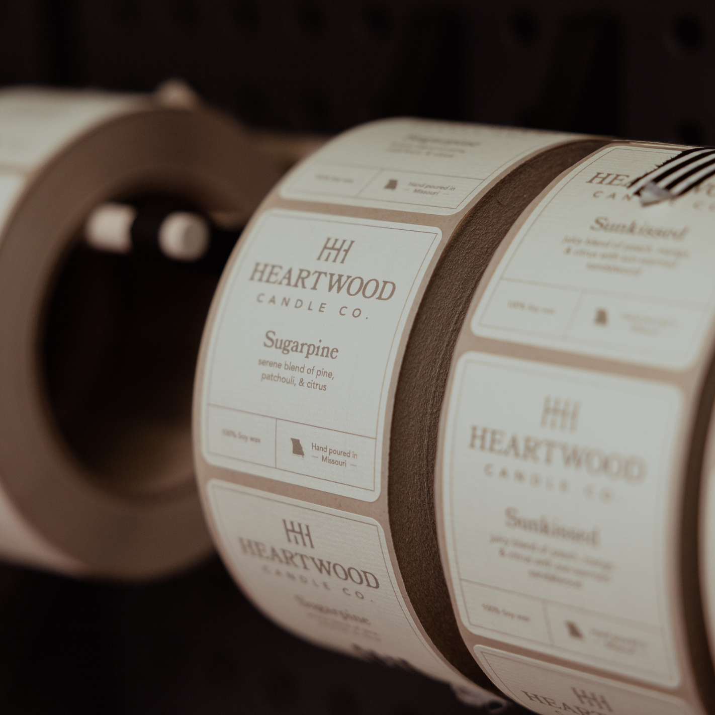 Fall soy candles being labeled by hand in Missouri