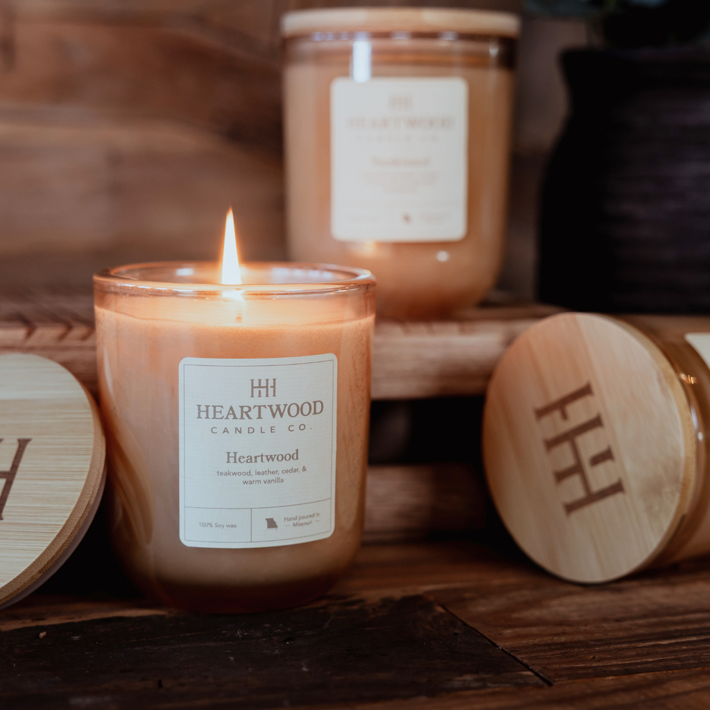 Refillable soy candles in champagne-colored glass jars with wooden lids