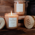 Refillable soy candles in champagne-colored glass jars with wooden lids